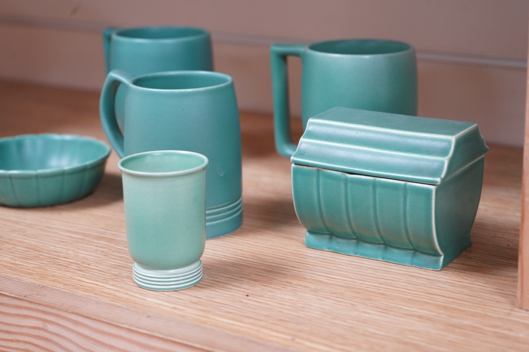 Keith Murray for Wedgwood, three green mugs, cigarette box, fluted dish and small vase, largest 12cm high (6)